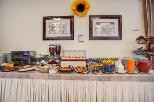 a buffet with many different types of food on a table at Hotel Tiziana in Rimini