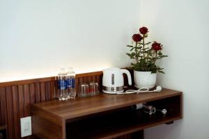 a wooden shelf with a coffee maker and a plant on it at Nori Home Đà Lạt in Da Lat