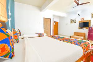 Säng eller sängar i ett rum på FabHotel Benz Destination Resort