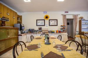 a dining room with a table and chairs at Hotel Tiziana in Rimini