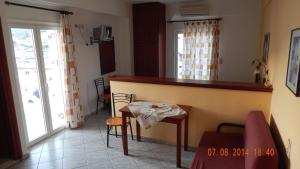 a kitchen with a counter and a table in a room at Costareli in Fournoi