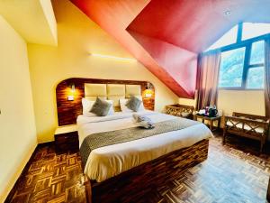 a bedroom with a large bed with a red ceiling at Kalinga's - Majestic Mountain View in Manāli