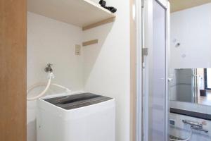 a small bathroom with a washer and dryer at REJ Reflet Ebisu in Tokyo +42 photos