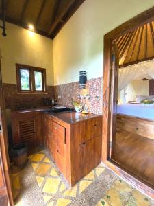 a kitchen with a wooden counter in a room at Lafyu Bali in Singaraja