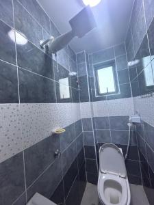 a bathroom with a toilet and a shower at 020-22 Airbnbs in Thika