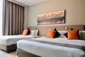 Postel nebo postele na pokoji v ubytování Qliq Damansara Hotel