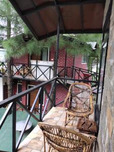 a patio with two chairs and a staircase at Zone Connect by The Park, Lansdowne in Lansdowne