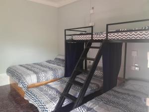 two bunk beds are in a room with at Vimeanz @Bohemiaz in Kampot