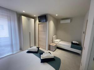 a bedroom with two beds and a bedvisor at Nonna Mina B&B in Rapagnano