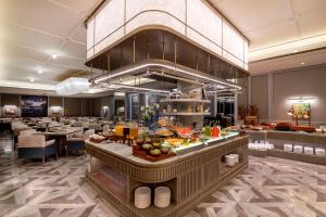 a breakfast buffet in a hotel room with a buffet at MaxX by Steigenberger Guangzhou Zhujiang New Town - Free Shuttle bus to Canton Fair Complex during Canton Fair Period in Guangzhou