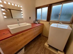 a bathroom with a sink and a mirror at CalmbaseRIVER - Vacation STAY 22009v in Numazu