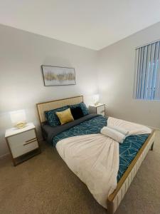a bedroom with a large bed and two night stands at The Plaisir - Pool & Spa in Santa Clarita