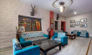 a waiting room with blue chairs and a table at Treebo Trend Megh Niwas - Jodhpur in Jodhpur