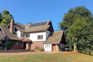 a house with a roof with solar panels on it at Lacebark Cottage in Hilton