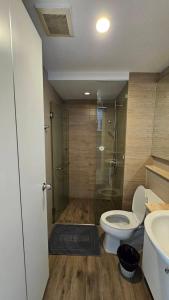a bathroom with a toilet and a shower and a sink at The Patio BangsaenF6 R71 in Ban Bang Saen (1) +4 photos