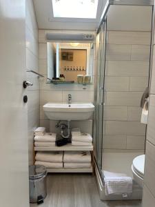 a bathroom with a sink and a mirror and towels at Bella Mura Nature Apartment Lipa 97 in Podčetrtek