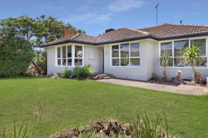 a house with a lawn in front of it at Scenic Serenity Large Family Home in Geelong in Geelong