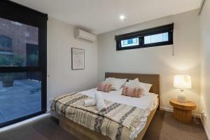 a bedroom with a bed and a large window at Retreat on Bellerine I Corporate or Getaway in Geelong