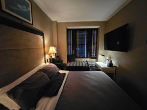 a bedroom with a large bed and a window at Hotel-Studio* @ The Mansfield Midtown in New York