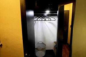 a closet with a white curtain in a room at Hotel-Studio* @ The Mansfield Midtown in New York
