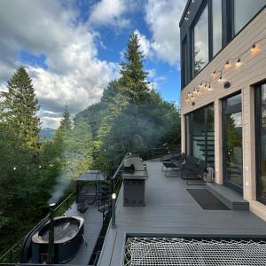 a deck with a hot tub and a grill at Forest Hub in Slavske