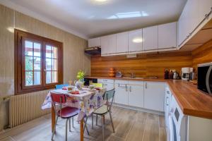 a kitchen with a table and chairs in a kitchen at Villa Madeleine in Saint-Cézaire-sur-Siagne +13 photos