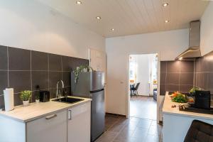 a kitchen with a stainless steel refrigerator and a counter at Deluxe Studio, PS4, Parken, Netflix, Klinikum in Bendorf