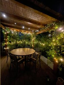 a patio with a table and chairs and lights at Amazing Design Apartment with Rooftop in Navigli - WiFi - Terraces - Garden in Milan