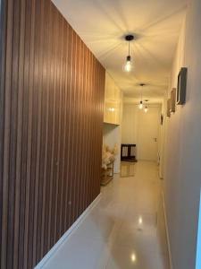 a hallway with a wood paneled wall and a long hallway at Homestay Cyberjaya AC Home 4R3B Free Wifi Netflix in Cyberjaya