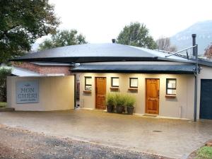 a building with doors and a sign on it at Mon Cheri Clarens in Clarens