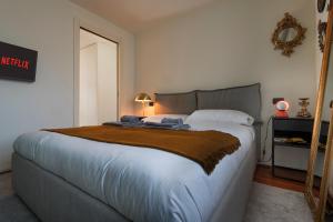 A bed or beds in a room at Giresio 41 - Your Penthouse with Rooftop Garden in Milano Navigli - WIFI
