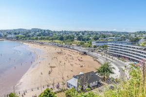 a view of a beach with people on it at Sea View Apartment, 7 Ellington Court in Torquay