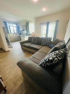 a living room with a couch and a kitchen at 2 bedroom multi-family home in Flic-en-Flac