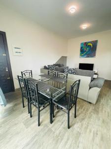a living room with a table and chairs and a couch at 2 bedroom multi-family home in Flic-en-Flac