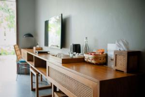 a kitchen counter with a sink and a mirror at Ecozy Dijiwa Canggu in Canggu
