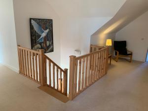 a staircase with a painting of a bird on the wall at Stroma, Dunnet, spacious holiday house with sauna. in Brough