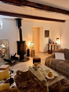 - un salon avec un canapé et un poêle à bois dans l'établissement Maison de montagne Alpes du sud/station Les Orres, aux Orres