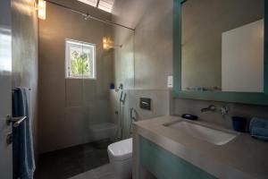 bagno con lavandino, servizi igienici e specchio di Nil Ralla a Talpe