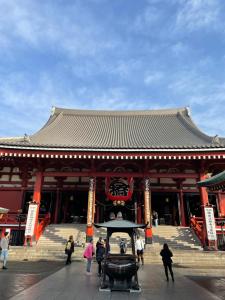 a large building with people walking in front of it at Hotel Crystal -大人専用-- in Tokyo