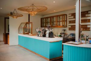 a kitchen with a blue and white counter top at Ecozy Dijiwa Canggu in Canggu
