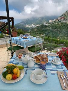 a blue table with plates of food on it at Appartamento Nonno Francesco in Ravello