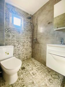 a bathroom with a toilet and a sink at Elegant Studio in the center of city. in Thessaloniki