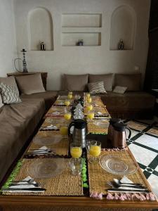 una sala de estar con una mesa con vasos de zumo de naranja en Riad Deluxe, en Marrakech
