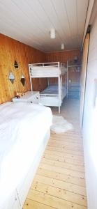 a bedroom with two beds and a wooden floor at Le Petit Idéal in Leykaul