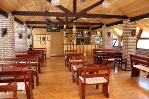 a dining room with wooden tables and chairs at Boutigue Hotel Nebesa in Chimgan