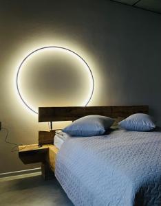 a bedroom with a bed with a large mirror on the wall at BRIVIBAS RESIDENCE - NORTH & SOUTH, free PRIVAT parking, free WIFI, self check-in in Rīga