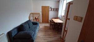 un soggiorno con un divano blu e un tavolo di Penzión Sandrik a Hodruša Altre 34 foto