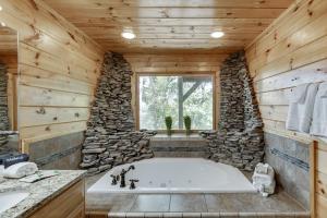 a large bathroom with a large tub in a log cabin at Deluxe Cabin For Groups Near Helen w Hot Tub in Cornelia +34 photos