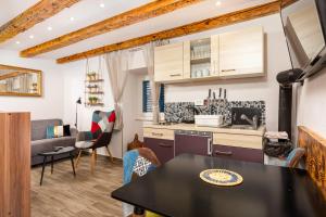 a kitchen and living room with a table and chairs at Villa 1900 in Kornić