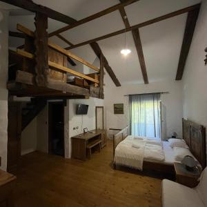 a bedroom with a loft bed and a desk and a bed at Country House Marića Gaj in Grude